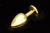 Пікантні Штучки - Велика золотиста анальна пробка з заокругленим кінчиком, 9х4 см (смарагдовий)